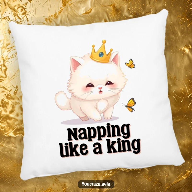 Funny cat pillow with a fluffy white cat wearing a golden crown, playfully chasing a butterfly, offering comfort and whimsical decor.