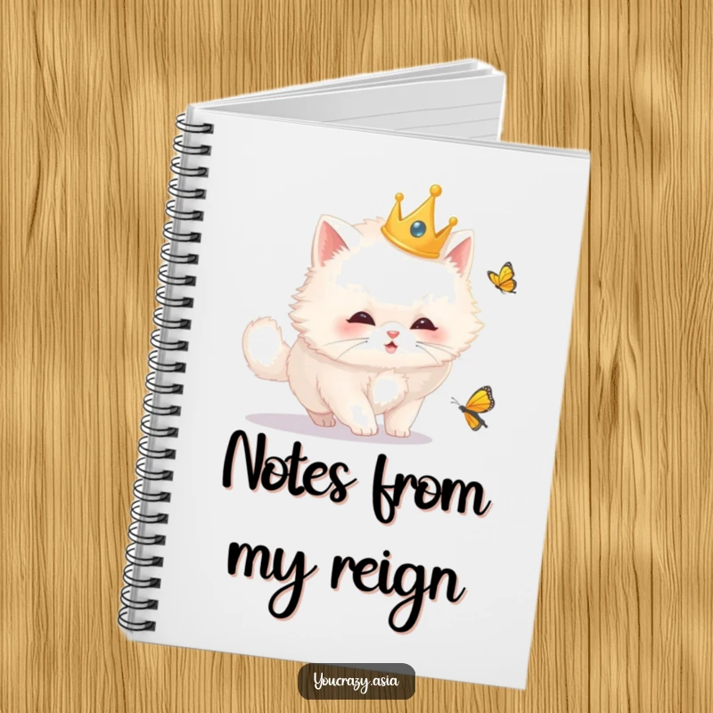Funny cat notebook with a fluffy white cat wearing a golden crown, curiously chasing a butterfly, designed for creative writing and journaling.